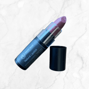 Flawless Glow Blush sits on a light marble background next to a mauve lipstick with its black cap beside it, labeled "Daisy Blue Natural Lipstick," for a radiant, coordinated look.