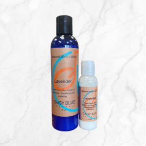 Two bottles of Lavender Lotion, one large and one small, sit on a white marble background. Both have blue and peach labels describing the lotion as soothing and calming.