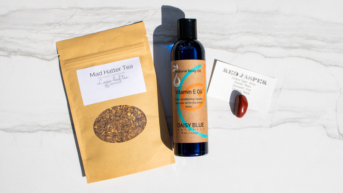 Daisy Blue April Trio, featuring the Mad Hatter Tea, Vitamin E Body Oil and Red Jasper Stone