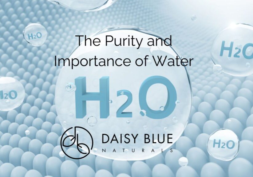 Large water droplets labeled "H2O" float over a textured, light blue background. Text reads: "The Purity and Importance of Water H2O," highlighting clean water above the Daisy Blue Naturals logo. The scene suggests freshness and cleanliness.