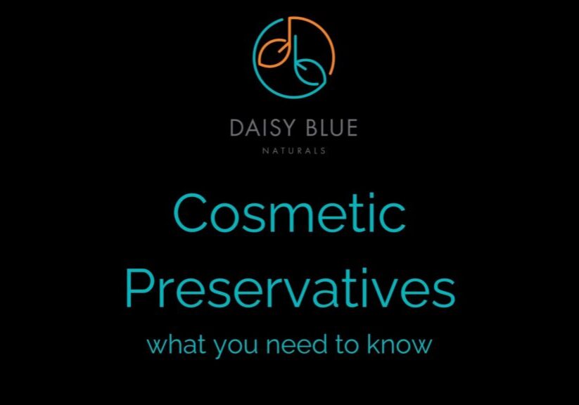 Black background with the Daisy Blue Naturals logo at the top. Large teal text reads "Cosmetic Preservatives," with "what you need to know" underneath—highlighting how natural products differ from those using synthetic preservatives.