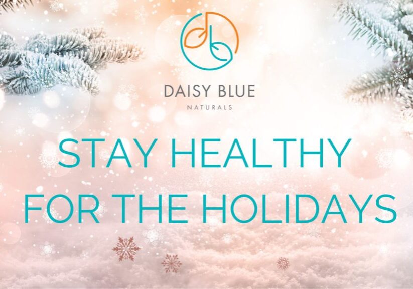 Snowy pine branches frame the top corners of a holiday-themed image with the Daisy Blue Naturals logo above "STAY HEALTHY FOR THE HOLIDAYS" in teal text. Snowflakes float over a pastel background, highlighting holistic wellness for the season.