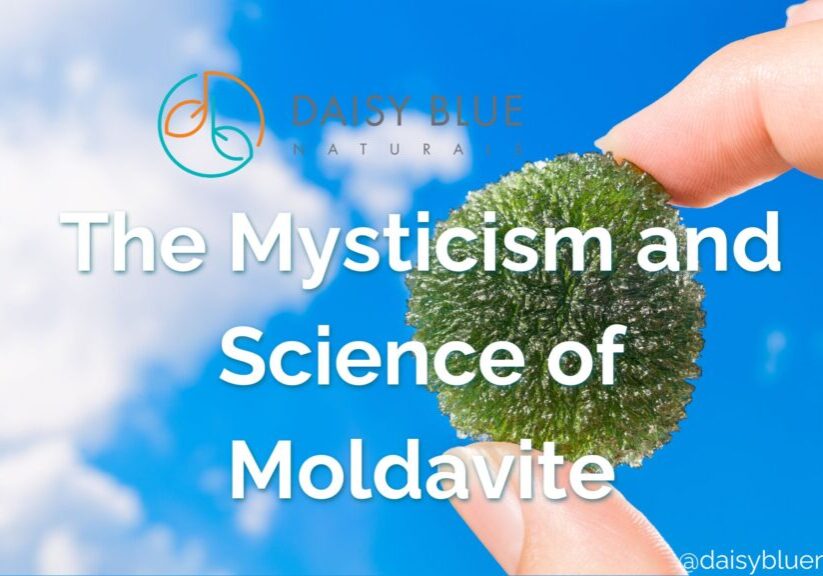 A hand holds a green moldavite stone against a blue sky with clouds. Text reads, "The Mysticism and Science of Moldavite." The Daisy Blue Naturals logo and social media handle highlight moldavite’s mysterious allure.
